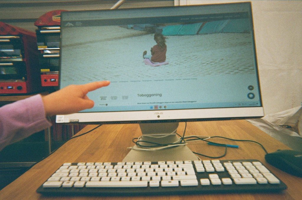A computer screen shows the Tobogganing activity at Mendip Activity Centre as part of a 3 day family camping itinerary.